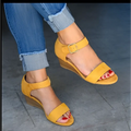 Tan suede wedge buckle strap sandals in yellow suede with gold buckle and wooden sole for fashion wedge buckle style