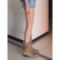 Tan suede western ankle boots with low block heel and decorative side flap in suede western cowboy pile style