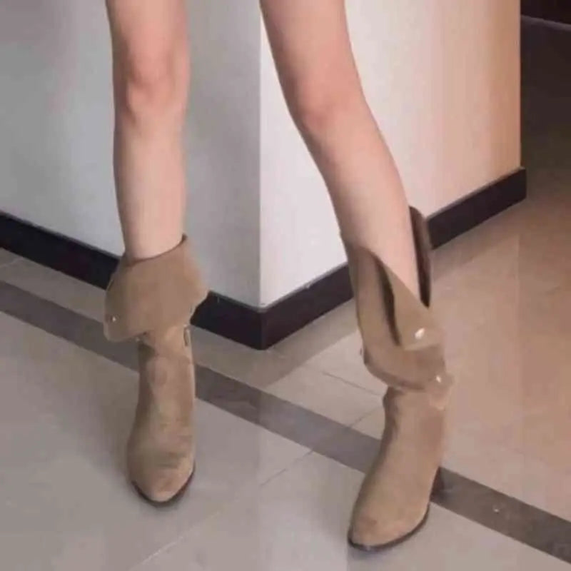 Tan suede western ankle boots with a slight heel and decorative ruffle in a cowboy pile style design