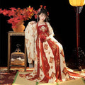 A woman wearing tang imperial han chinese clothing recovery dress in red and cream with floral embroidery details