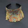 A vibrant tassel diamond pearl bridal headband set with multi-colored beads, gold-toned crystals, and rainbow rhinestones