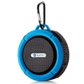 Teal and black portable waterproof speaker with carabiner clip for outdoor use and convenient portability