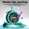 Teal and black portable waterproof speaker with mesh grille, carabiner clip, and branded logo for outdoor use