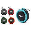 Teal and black portable waterproof speaker with carabiner clip and textured grip handle for easy portability