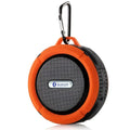 Orange and black portable waterproof speaker with carabiner clip designed for outdoor use and active lifestyles