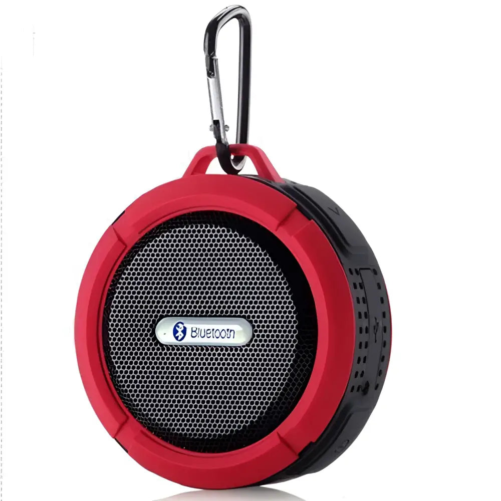 Red and black portable waterproof speaker with carabiner clip designed for active use in luxury women’s fashion settings