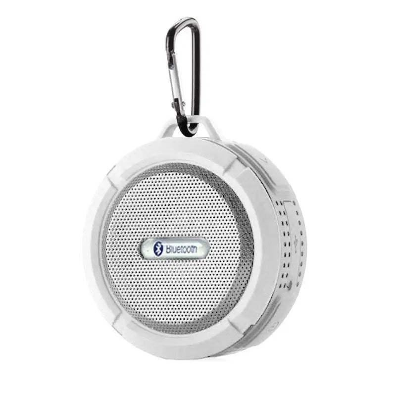 White portable waterproof speaker with perforated grille and carabiner clip for outdoor use in luxury women’s fashion settings