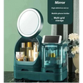 Teal cosmetics storage box with built-in LED lighting, modern vanity organizer with circular led-lit mirror and transparent compartments