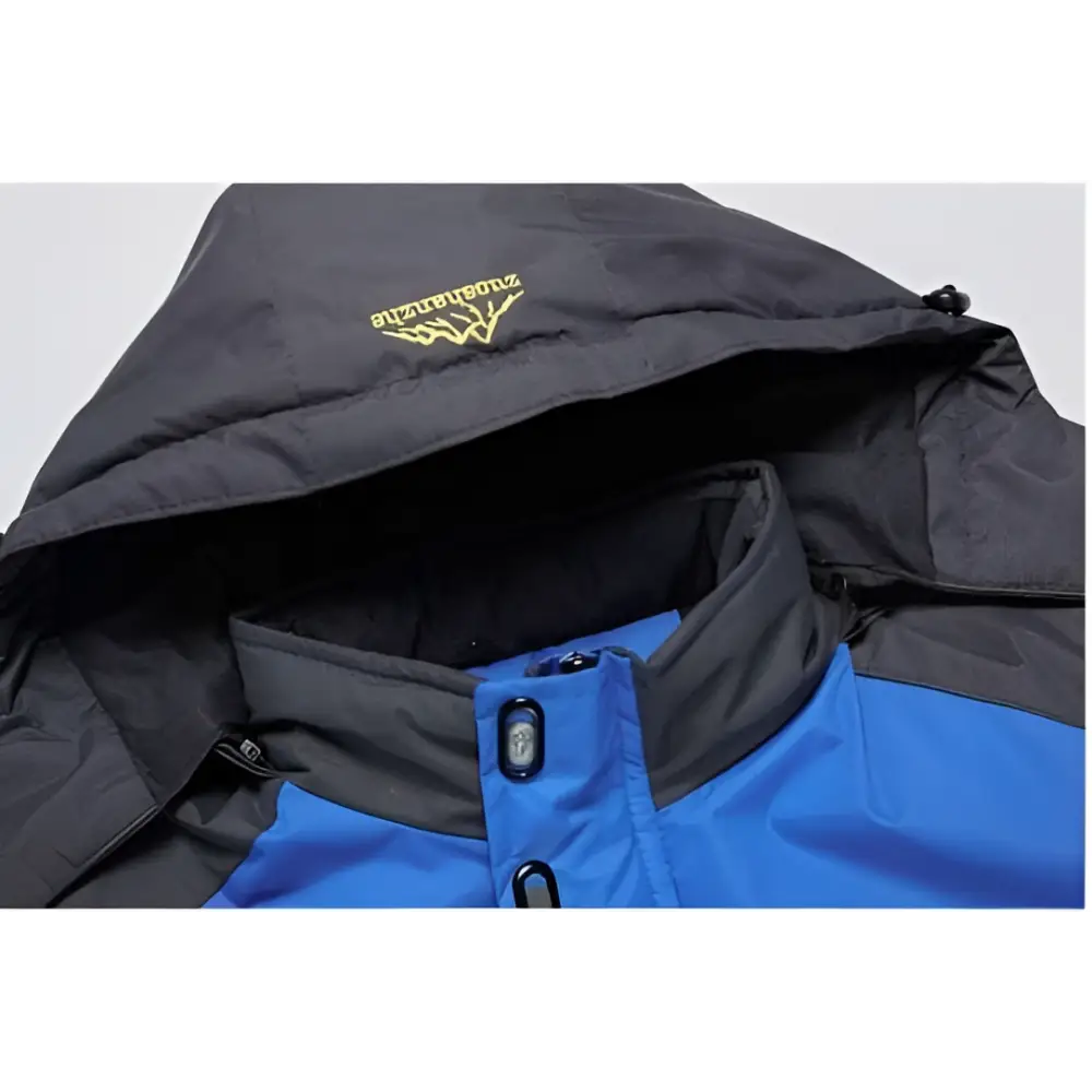 Teal mens harsh winter jacket waterproof hiking hooded in blue and black with yellow embroidered logo on the hood