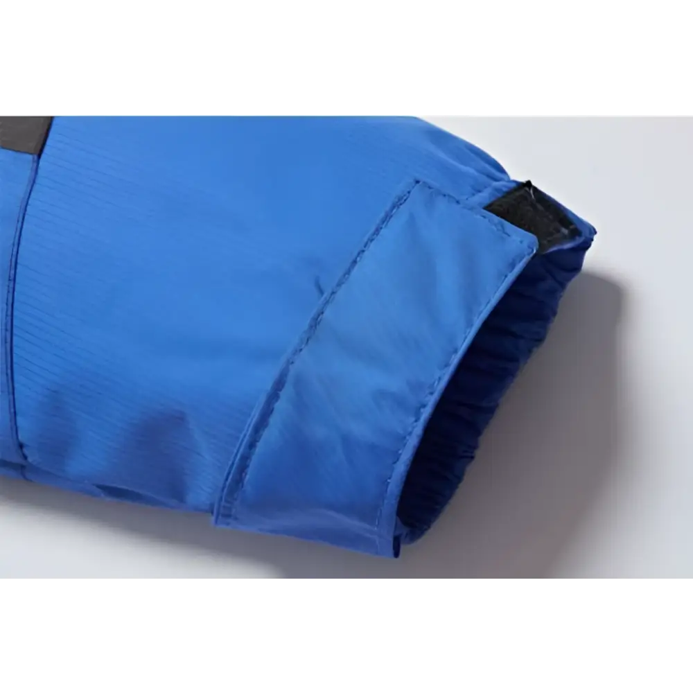 Blue nylon sleeve with black elasticated cuff on teal mens harsh winter jacket waterproof hiking hooded design