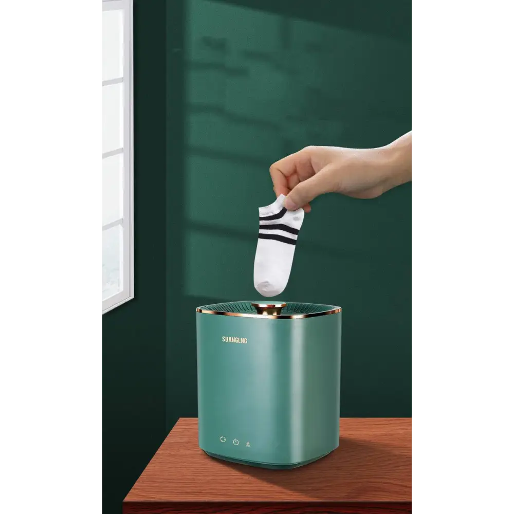 Teal mini portable washing machine with gold-trimmed edges and minimalist design for efficient mini portable use