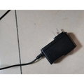 Black plastic power adapter with two-prong plug and coiled cord for teal mini portable washing machine