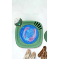 Teal mini portable washing machine with a green square body, blue swirling liquid center, and black edge slits for efficient mini portable use