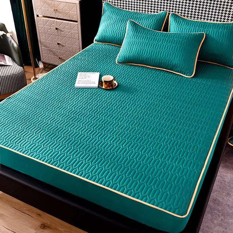 Teal quilted dust-proof single-piece fitted sheet with subtle geometric pattern and cream-colored piping edges