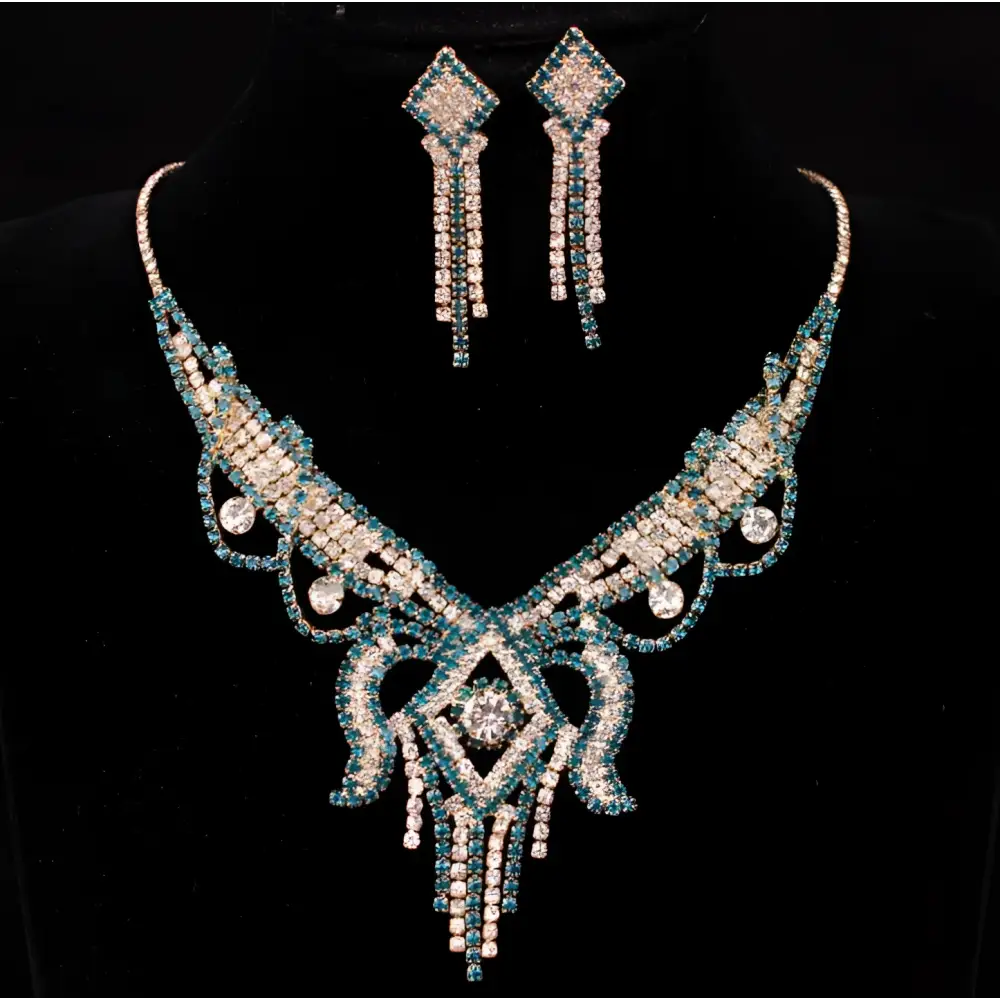 A teal rhinestone american exaggerated butterfly jewelry set featuring a silver necklace with diamond centerpiece and matching earrings