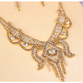 Gold-colored rhinestone American exaggerated butterfly jewelry necklace with clear cascading rhinestones in an intricate design