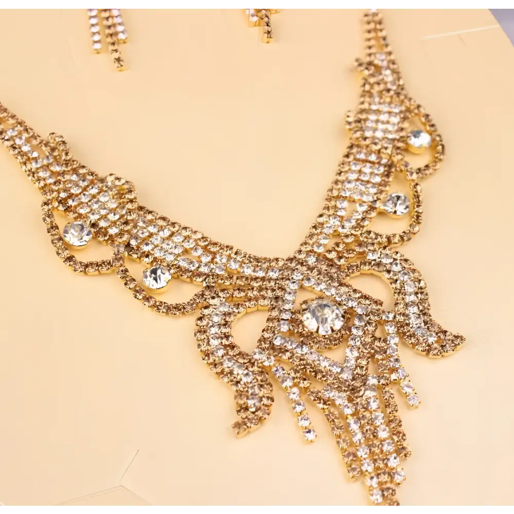 Gold-colored rhinestone American exaggerated butterfly jewelry necklace with clear cascading rhinestones in an intricate design