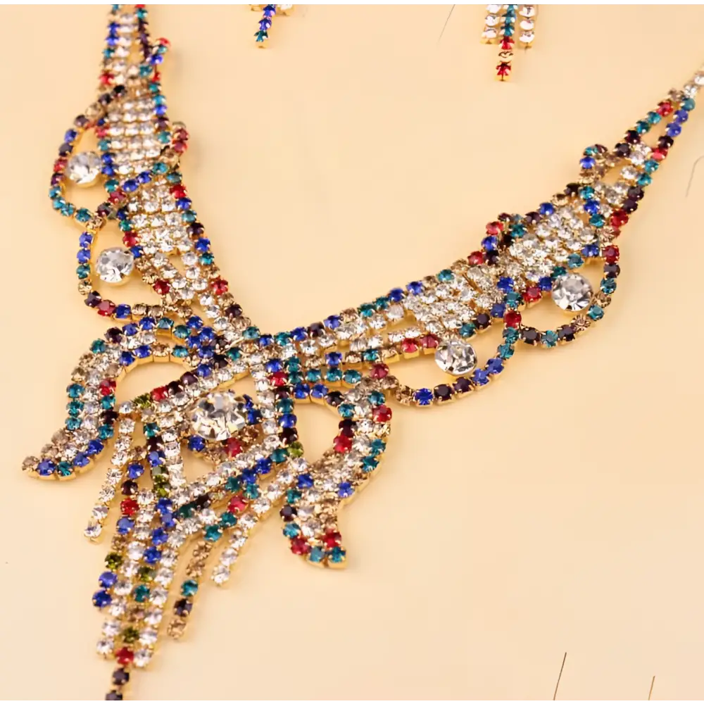 A gold-toned rhinestone american exaggerated butterfly jewelry set with vibrant clear, blue, red, and green stones