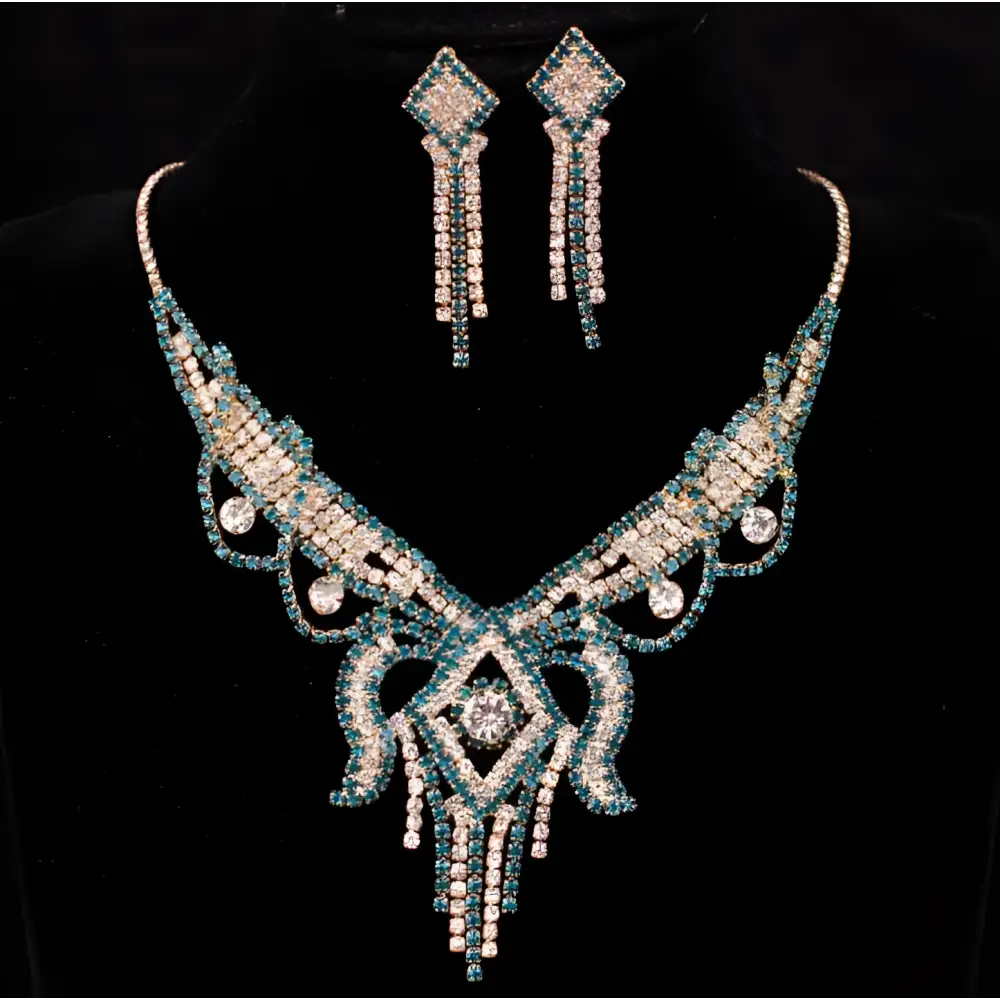 A sparkling teal and silver rhinestone American exaggerated butterfly jewelry set with diamond-shaped centerpiece and tassels