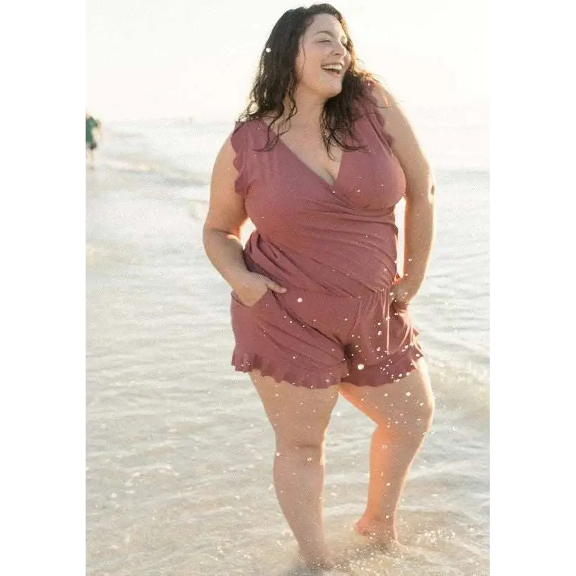 A soft mauve ruffled romper with wrap-style front and side pockets contrasting teal ruffled deep one-piece swimsuit with built-in bra suitable for hot spring boxer use