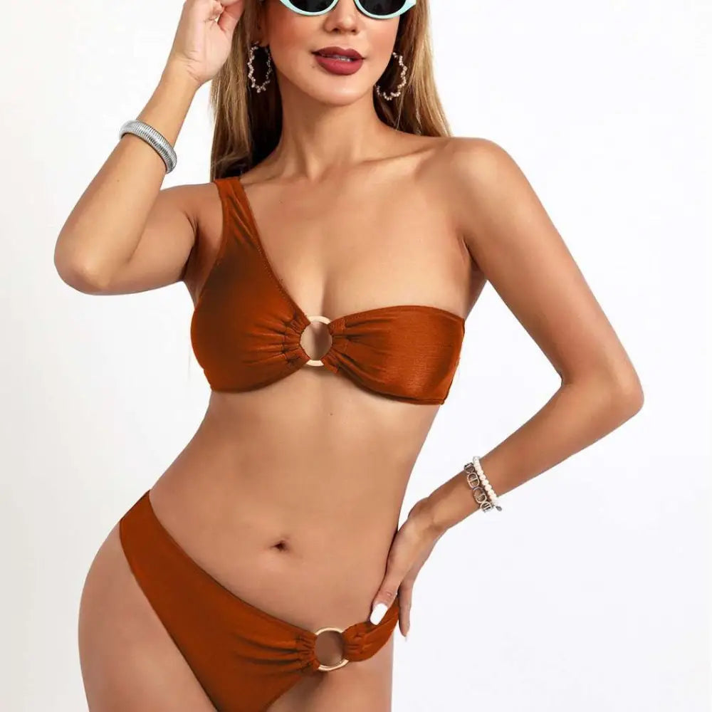 A stylish rust-colored split sexy bikini one-piece with ruched nylon starlight fabric and gold rings accents