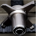 Shiny chrome bicycle hub with star-shaped multi-spoke design and black tire tread in telescopic self-defense anti-cut stick image