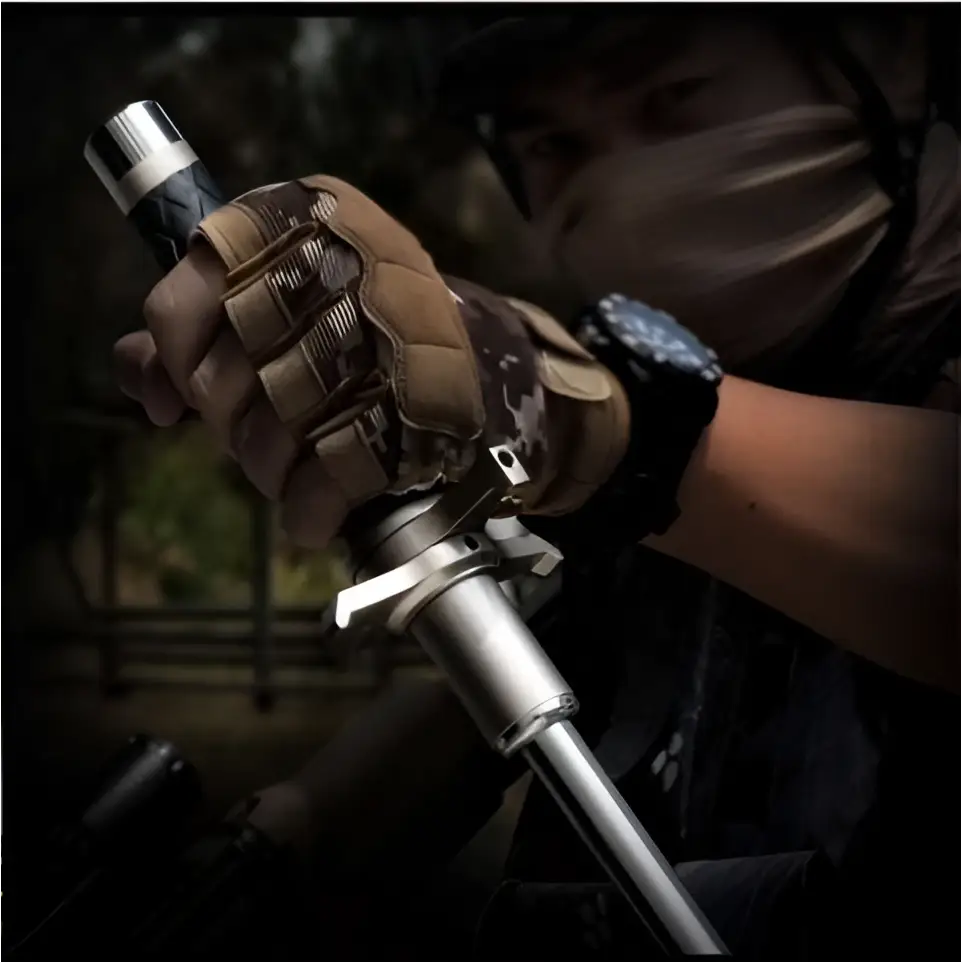 A telescopic self-defense anti-cut stick with a metallic silver body and black grip held in gloved hands by royale essence lux