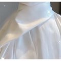 A flowing white tulle skirt with soft layered texture and gentle folds of temperament princess style french satin gown with fitted bodice