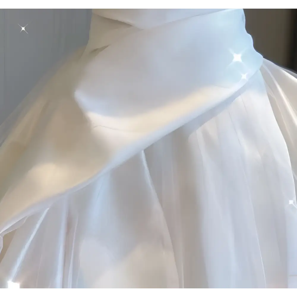 A flowing white tulle skirt with soft layered texture and gentle folds of temperament princess style french satin gown with fitted bodice