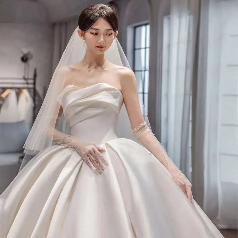 Temperament princess style ivory satin wedding gown in french satin with strapless sweetheart neckline and sheer lace gloves