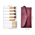 Ten piece makeup brush set with maroon leather case featuring white handles and gold ferrules in a beauty complete kit