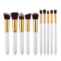 Set of ten makeup brushes with white handles gold ferrules and dark brown bristles in maroon case beauty complete kit