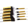 Ten piece makeup brush set with gold ferrules black to gray bristles and white handles in maroon case beauty complete kit