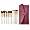 Ten piece makeup brush set with white handles gold ferrules dark brown bristles and a maroon case beauty complete kit