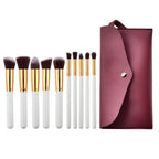 Ten piece makeup brush set with white handles gold ferrules dark brown bristles and a maroon case beauty complete kit