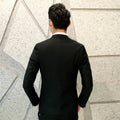 Black men’s suit tailored jacket with textured fabric and subtle sheen in a men’s suit three-piece design