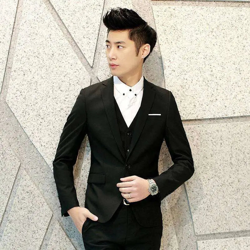 Black men’s suit three-piece with textured tailored fit and subtle white pocket square for formal occasions