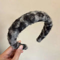 A cozy gray and black woolen headband with a soft fuzzy surface for textured winter plush bow hair clip use