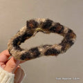 Cozy plush leopard bow hair clip with a textured winter plush chunky knit in black and beige tones