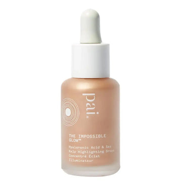 A sleek transparent glass bottle with white dropper cap contains pale peach impossible glow glow hyaluronic acid and sea kelp drops