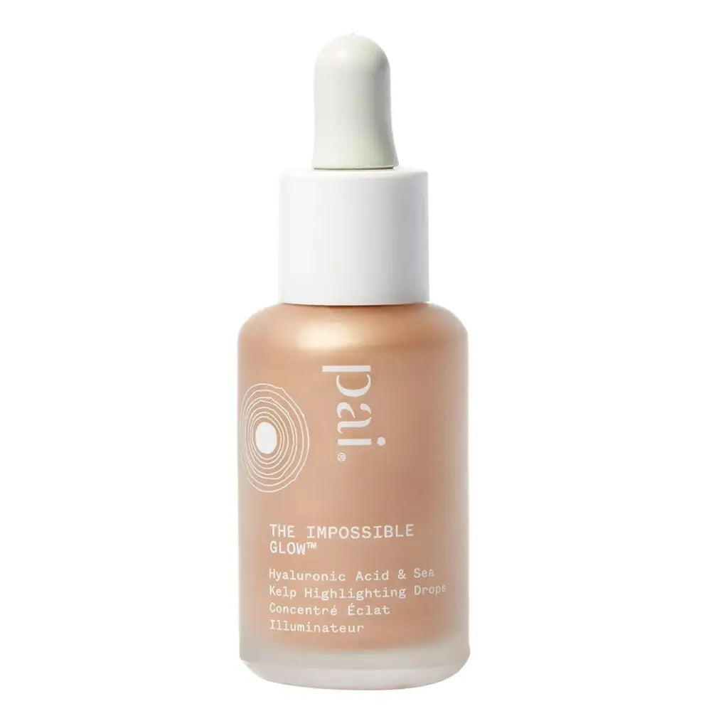 A sleek transparent glass bottle with white dropper cap contains pale peach impossible glow glow hyaluronic acid and sea kelp drops