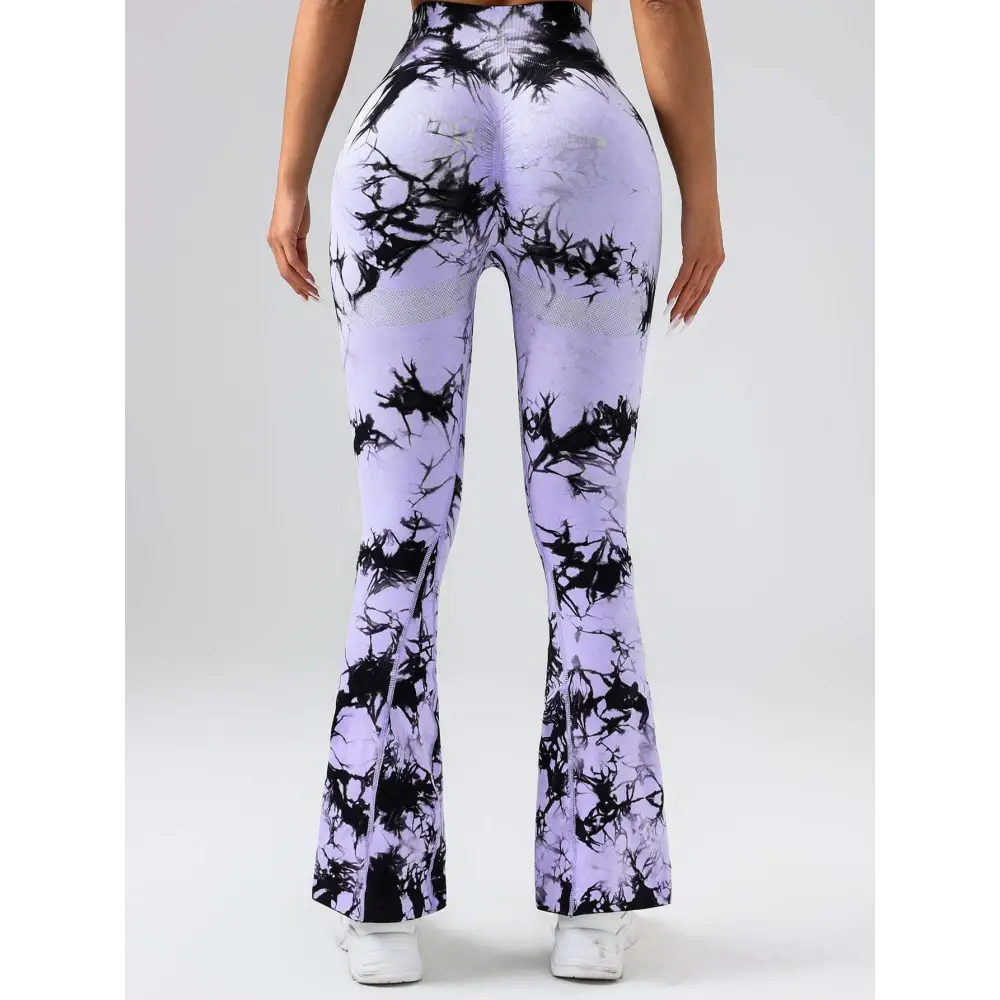Purple and black tie dye tummy control flare yoga pants with mesh hip panels and butt lift design