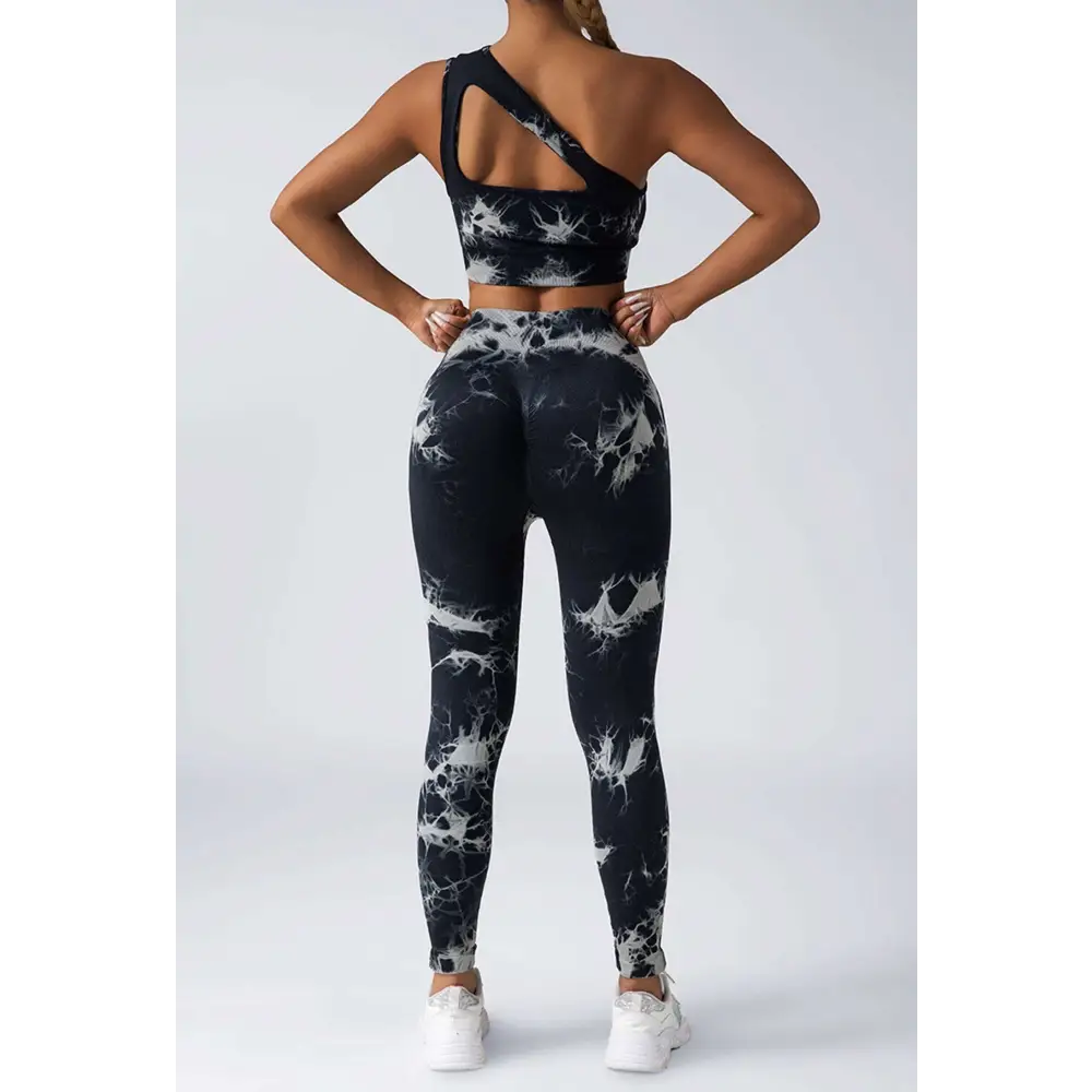 Black and white tie dye women’s scrunch butt yoga set featuring high-waisted leggings and one-shoulder crop top