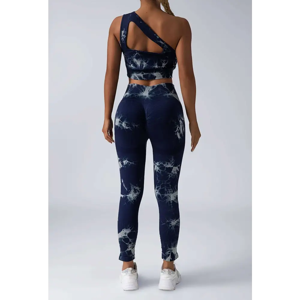 Navy blue and white tie dye women’s scrunch butt yoga set featuring a one-shoulder crop top and high-waisted leggings