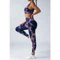 A navy and lavender tie dye women’s scrunch butt yoga set with crop top and high-waisted leggings for activewear