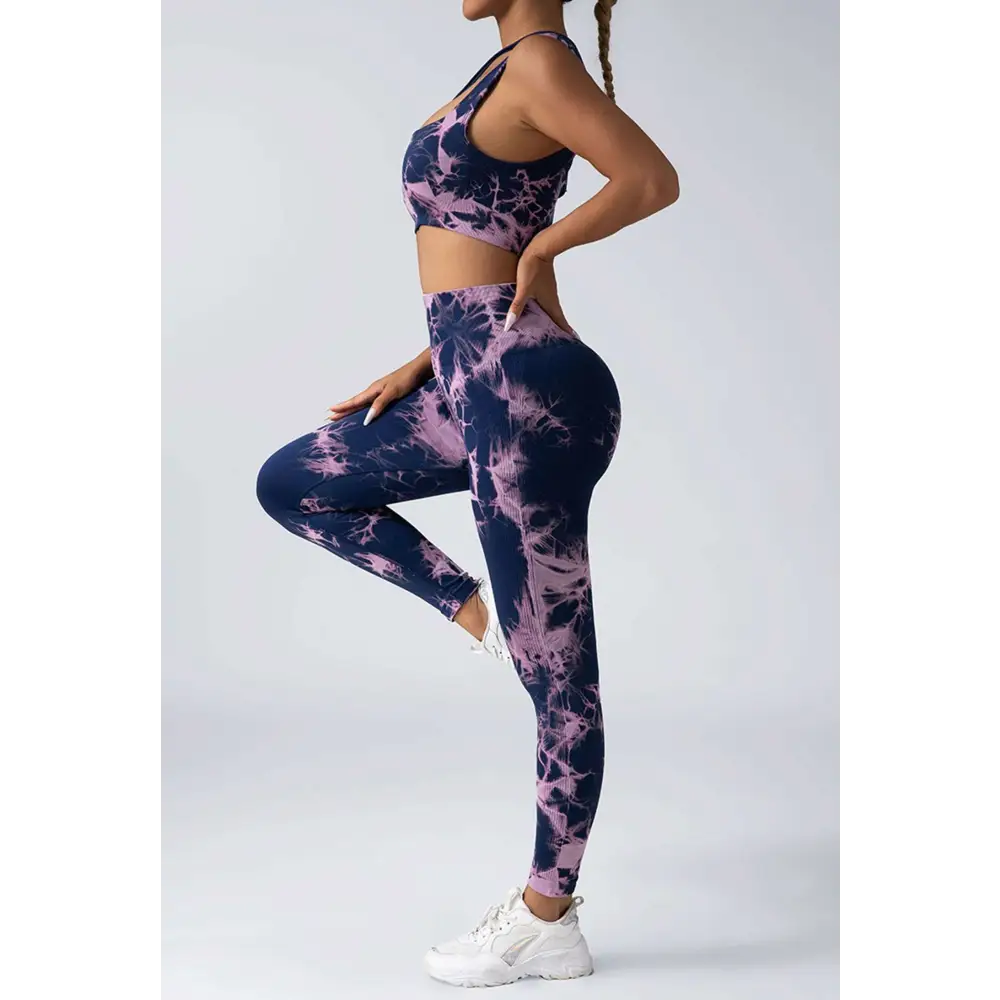 A navy and lavender tie dye women’s scrunch butt yoga set with crop top and high-waisted leggings for activewear