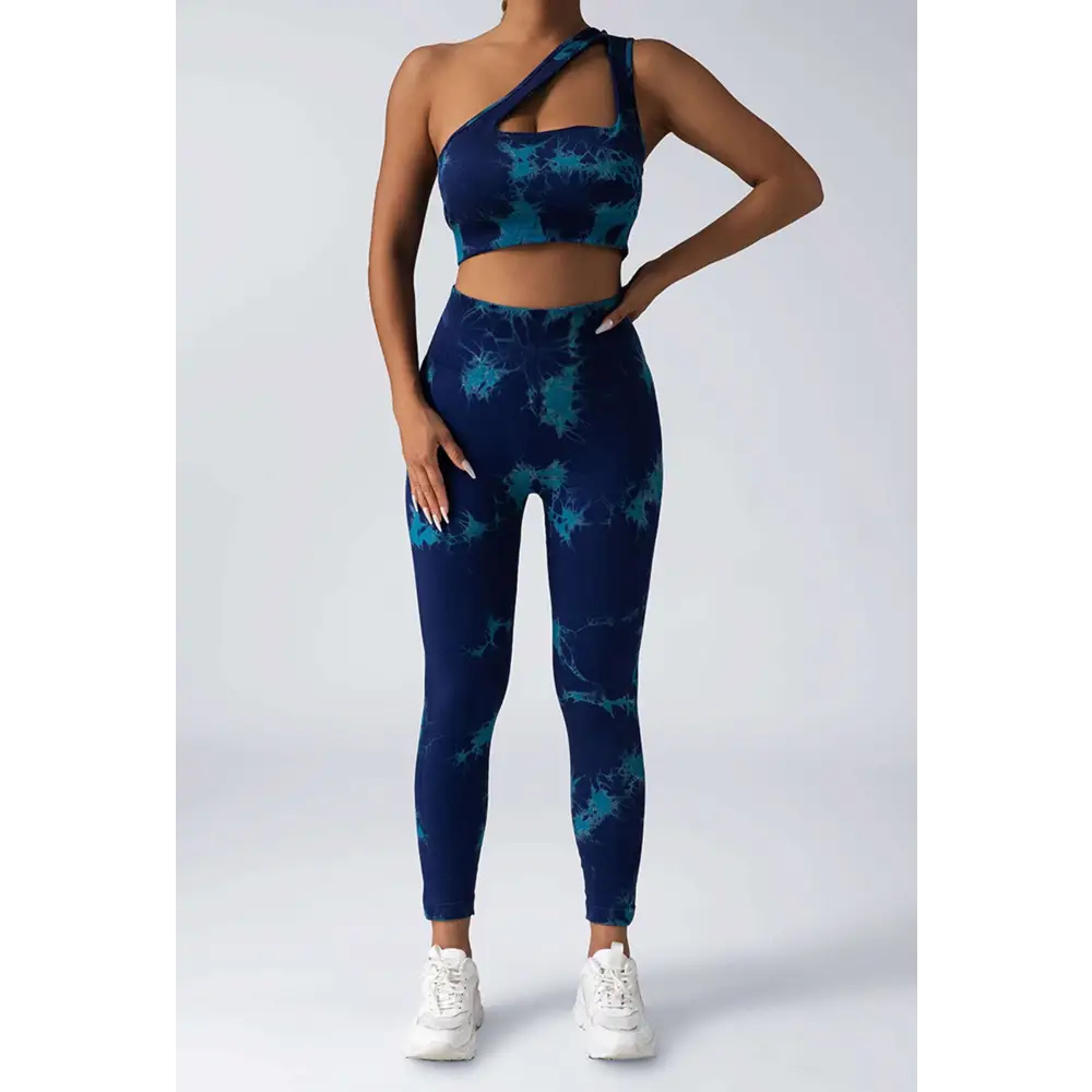 Blue and teal tie dye women’s scrunch butt yoga set with one shoulder crop top and high waisted leggings
