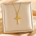 Titanium steel double ring zircon pendant necklace featuring a gold cross with heart-shaped knot and clear crystals in gift box
