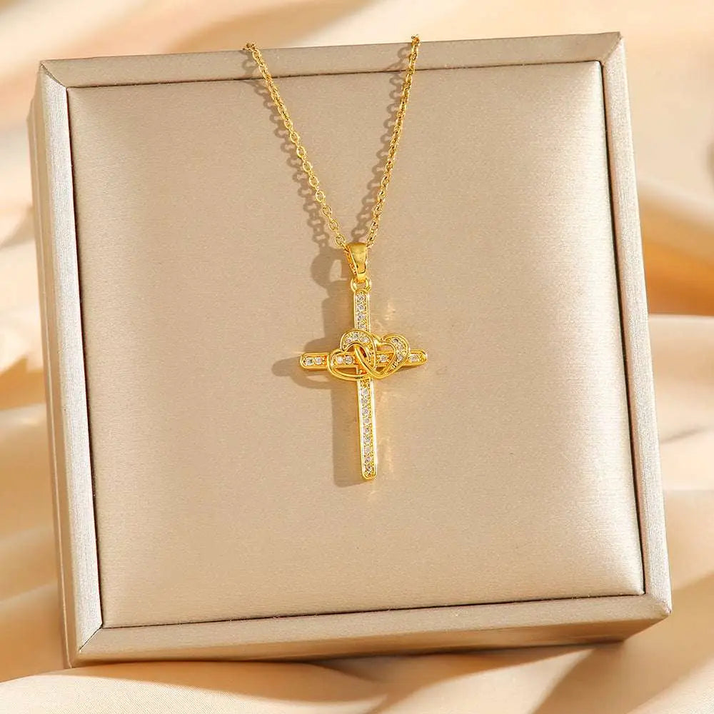 Titanium steel double ring zircon pendant necklace featuring a gold cross with heart-shaped knot and clear crystals in gift box