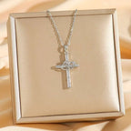 Titanium steel double cross double ring zircon pendant necklace with silver heart-shaped knot and clear crystals on beige box